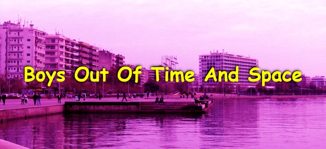 Thessaloniki’s seafront promenade with people walking along the waterfront, the Umbrellas sculpture in the background, and the Makedonia Palace hotel under a pink-tinted sky.